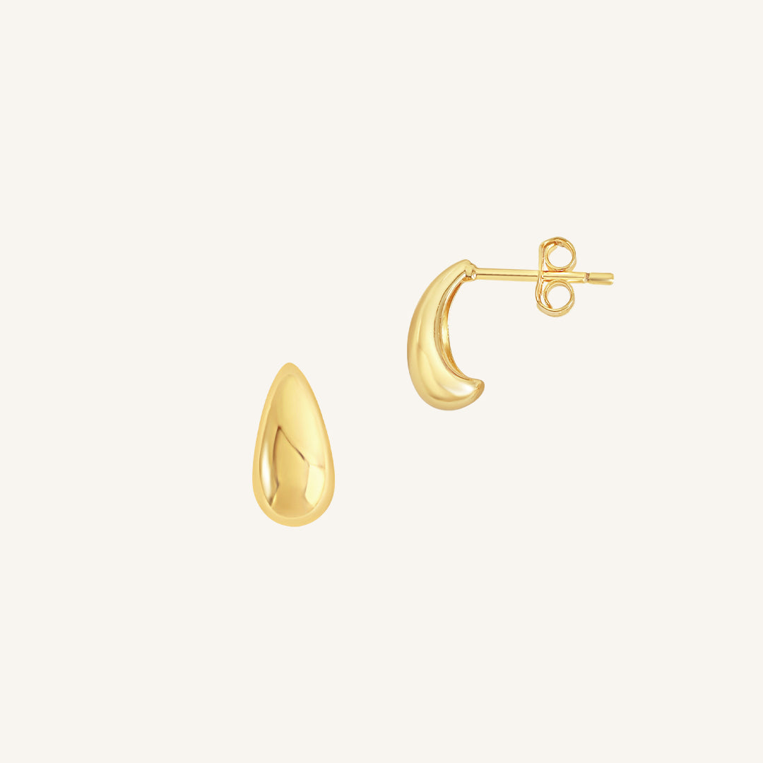 A pair of gold-colored stud earrings with a smooth finish.
