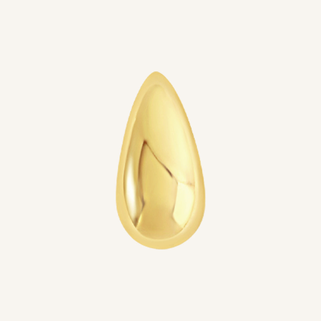 A gold stud earrings with a smooth finish, close up.