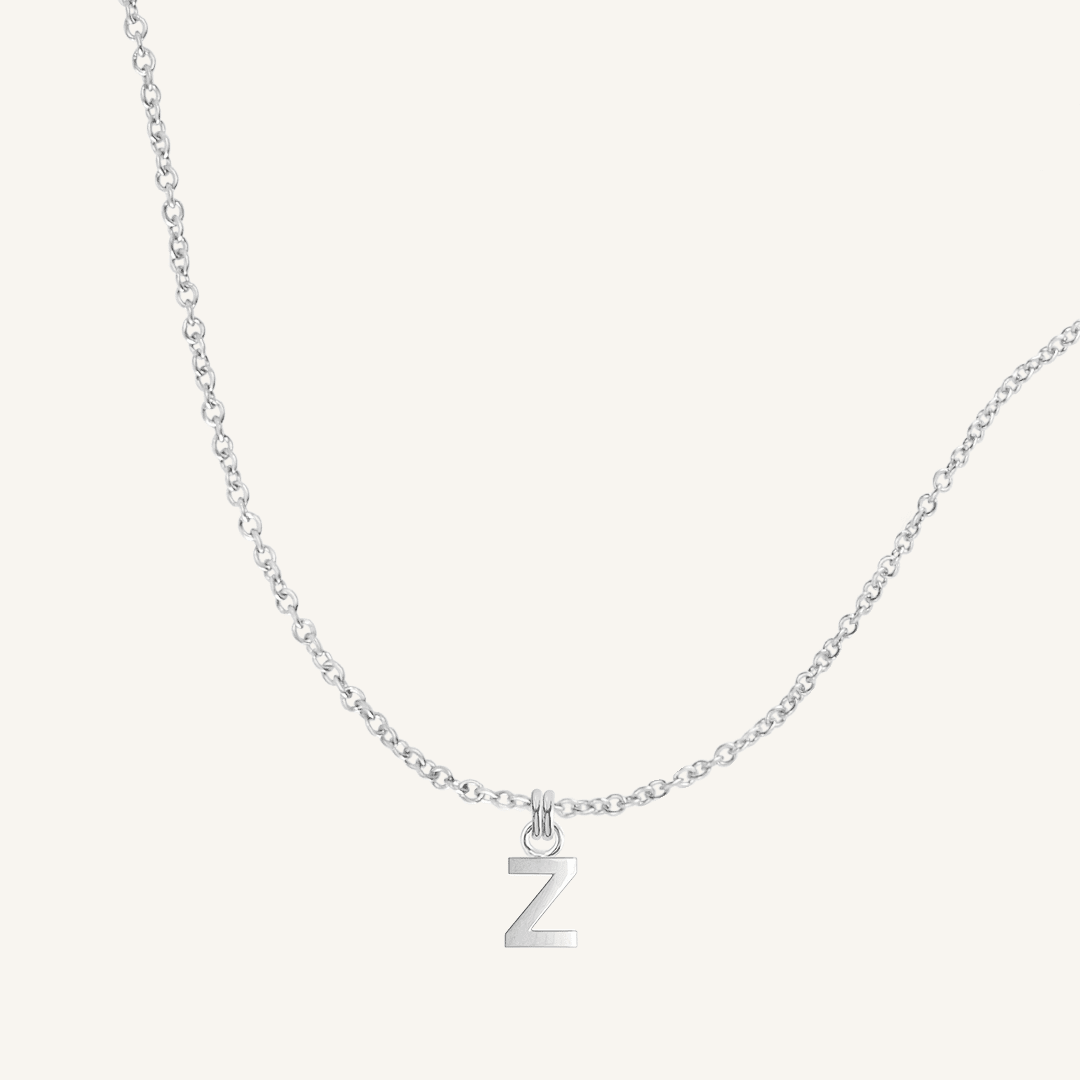Silver necklace with a 'Z' pendant on a light gray background