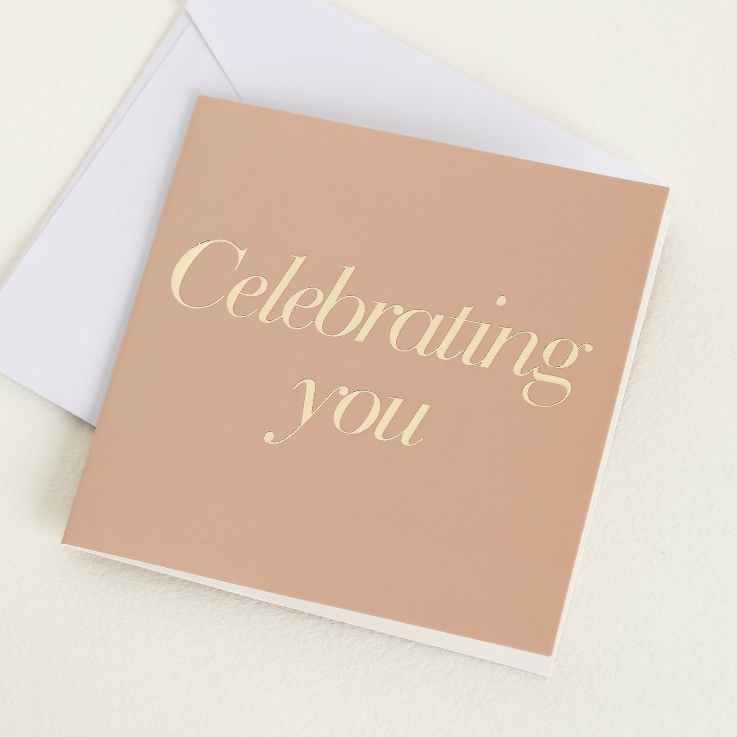 A greeting cards displayed on a neutral background, featuring designs such as 'celebrating you'.
