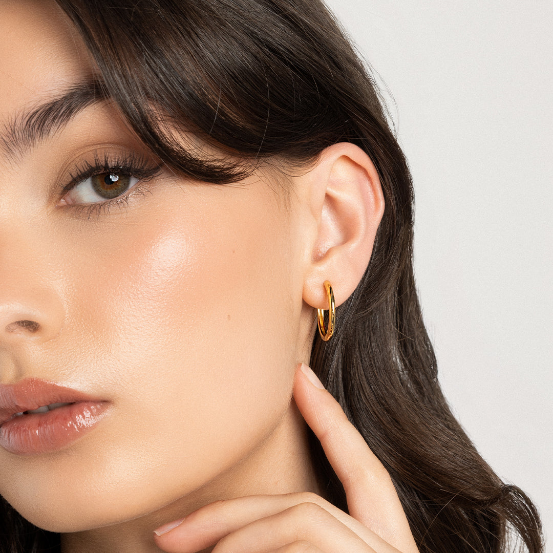 gold hoops, worn in models ear