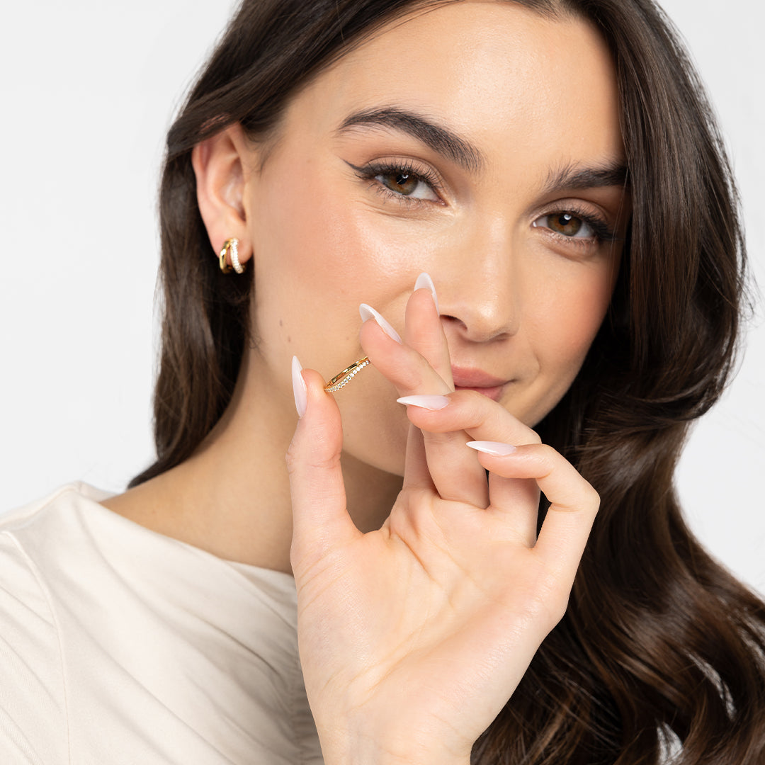 A slim, elegant ring with multiple small cubic zirconias set in a coloured band, close up