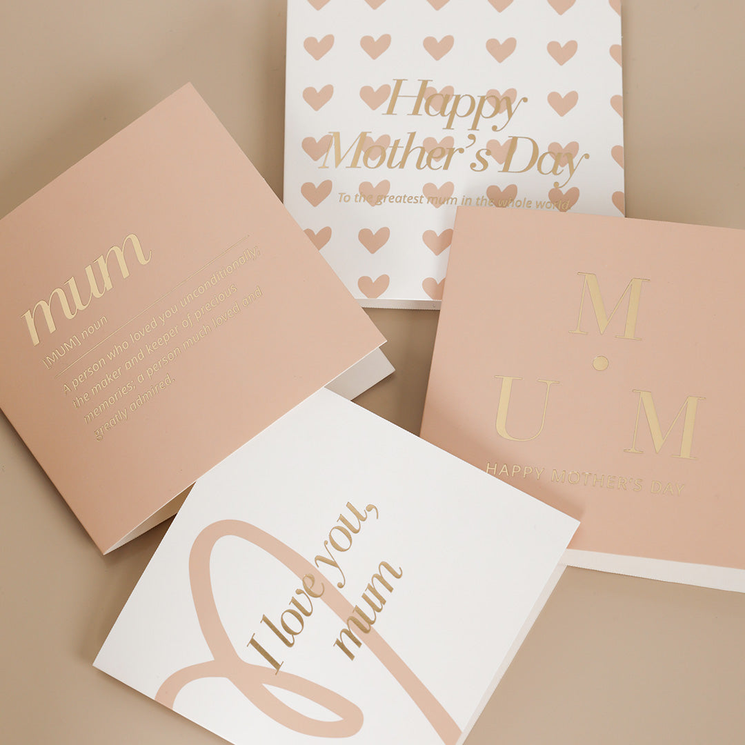 A selection of greeting cards displayed on a neutral background, featuring designs such as 'Happy Mother's Day', hearts, and the words 'mum' along with a general 'Love you mum' message.
