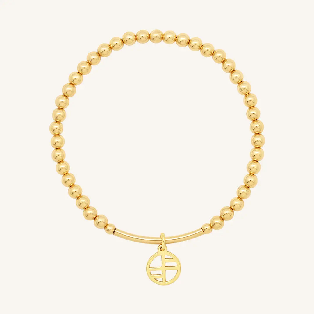A gold-tone charm bracelet with 4mm beads and a charm pendant hanging in the center.