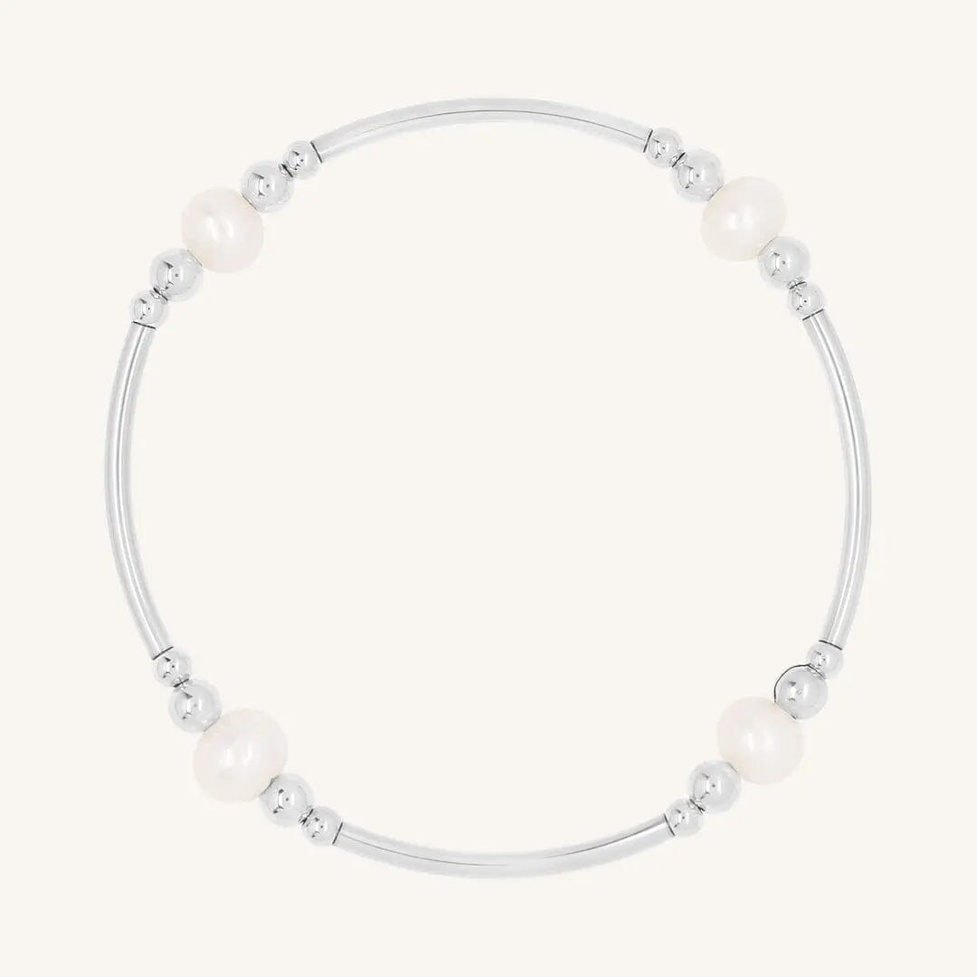 A silver bracelet with natural freshwater pearls, designed with a beaded pattern.