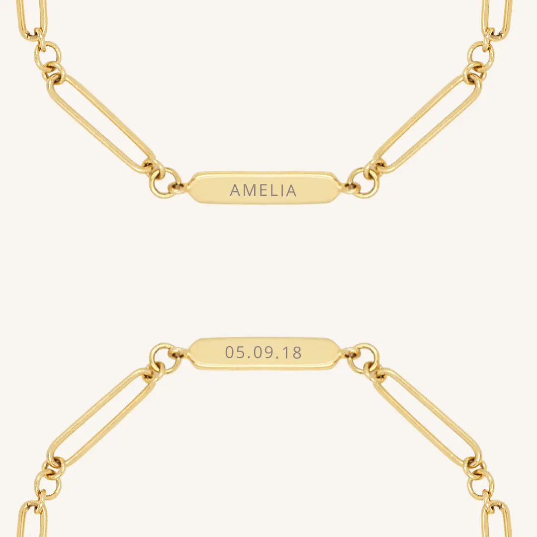 A gold chain bracelet with an engraveable panel.