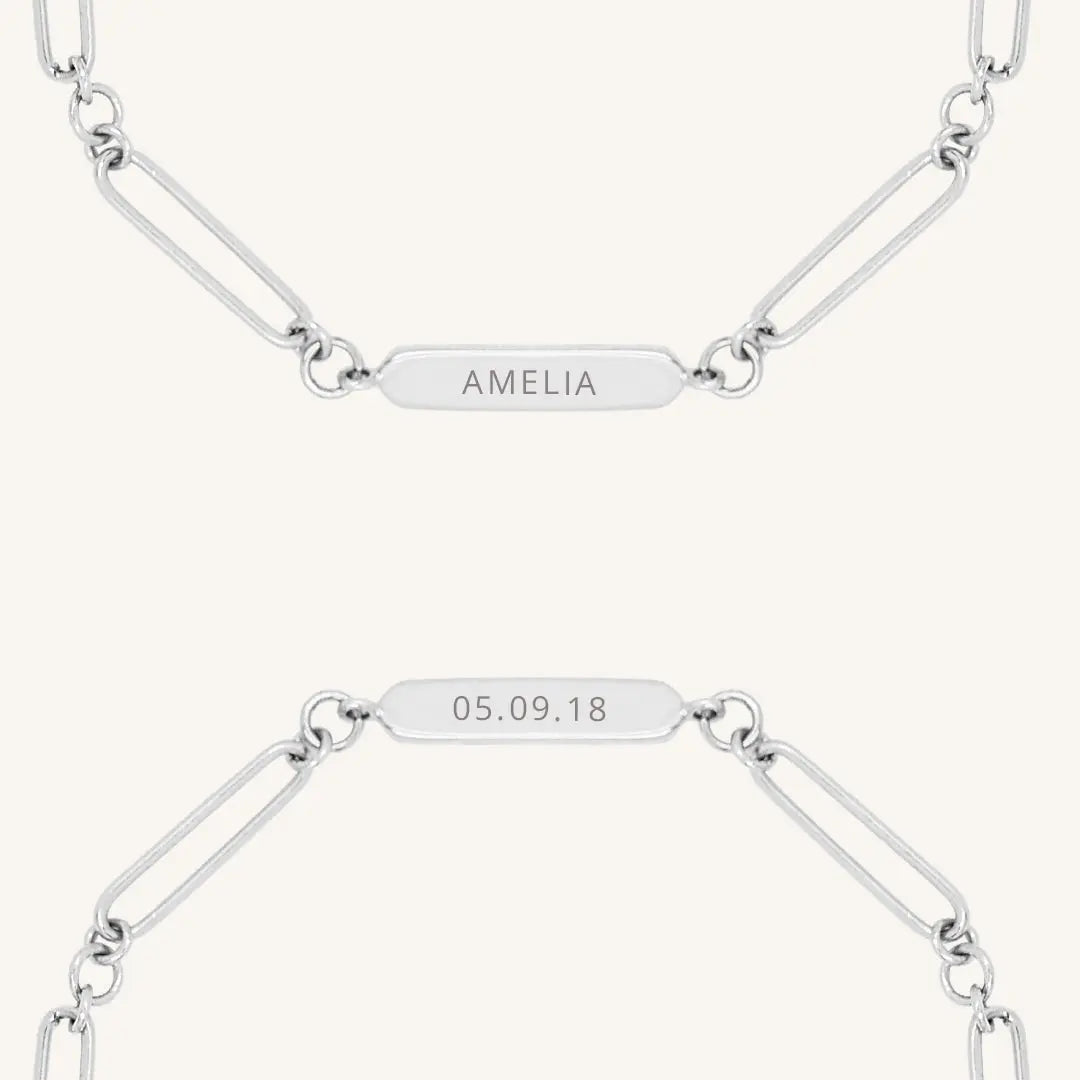 A silver chain bracelet with an engraveable panel.