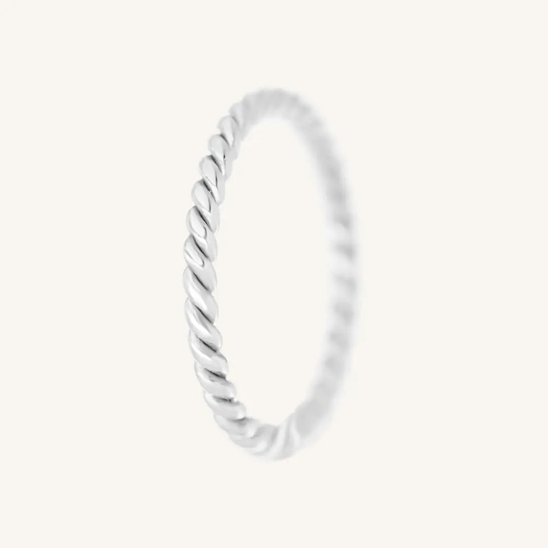 A silver-coloured stacking ring with a twisted design, displayed against a white background.