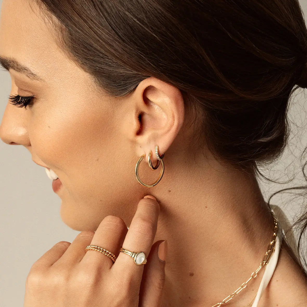 Large gold hoops, worn by model