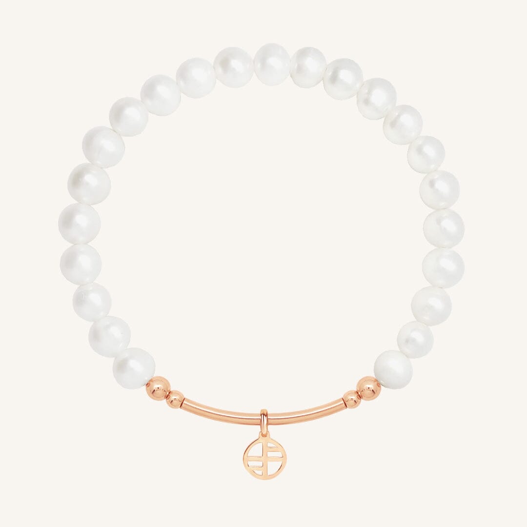 Pearl bracelet with a rose gold clasp on a white background