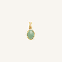 Gold pendant with a green stone on a white background