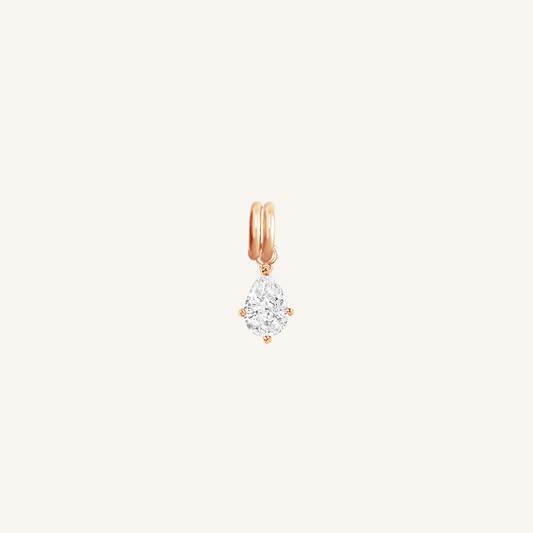 A teardrop-shaped cubic zirconia charm with a rose metal tone