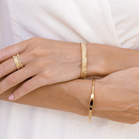 Silver ring with textured design on a white background