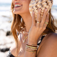 Silver charm with a pink gemstone on a white background