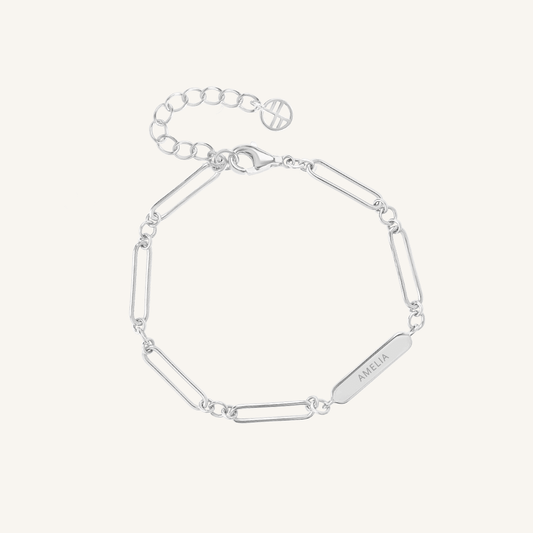 A silver-tone bracelet with a chain design and an engraving bar, displayed against a white background, made for children