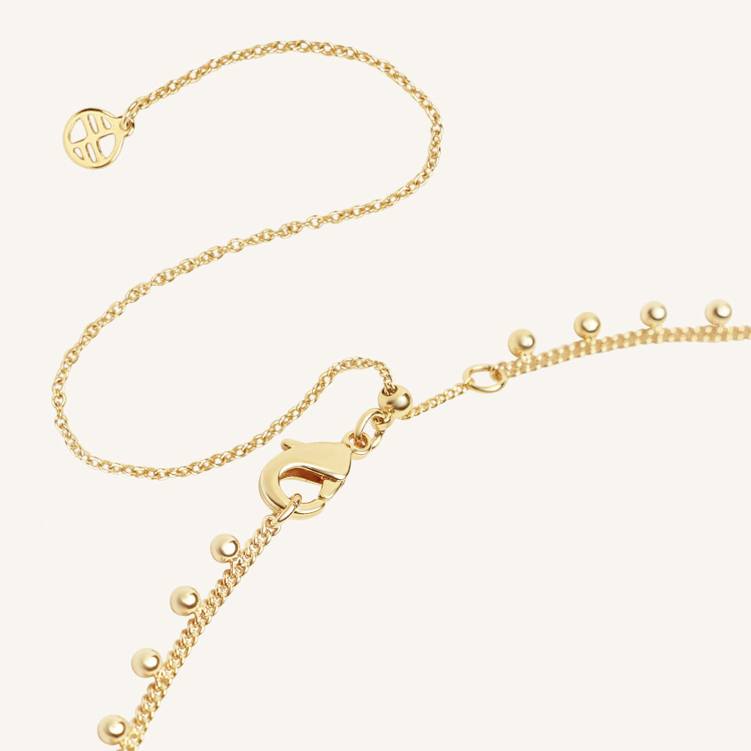 Gold necklace with a clasp on a white background