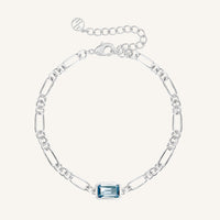 Silver bracelet with a blue gemstone on a white background