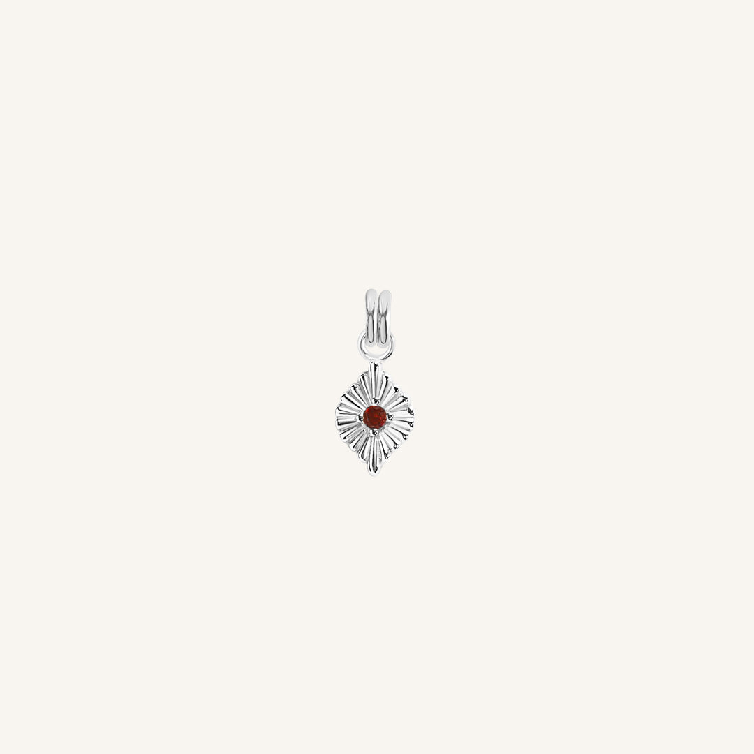 A silver birthstone charm with a red cubic zirconia representing the month of January.