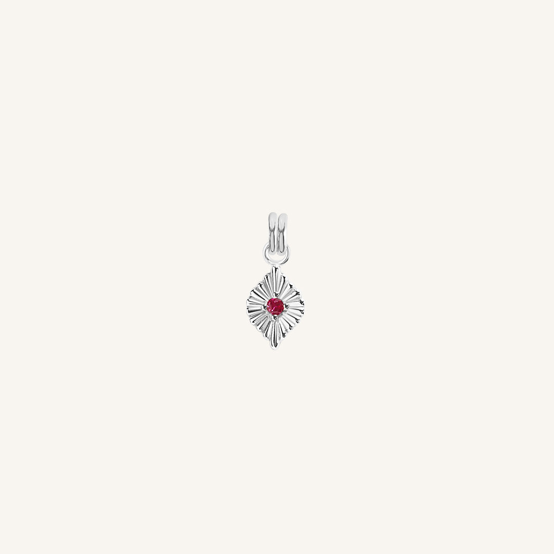 A silver birthstone charm with a ruby cubic zirconia representing the month of July.