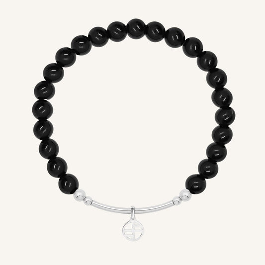 Black beaded bracelet with a silver bar on a white background