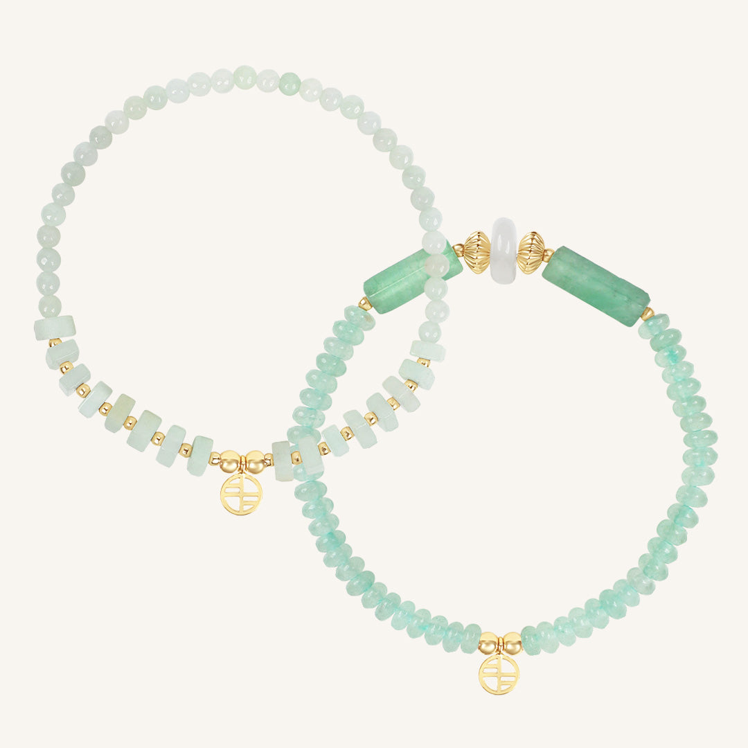 Set of green beaded bracelets with gold accents on a white background
