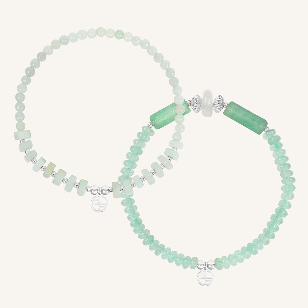 Set of green beaded bracelets with gold accents on a white background