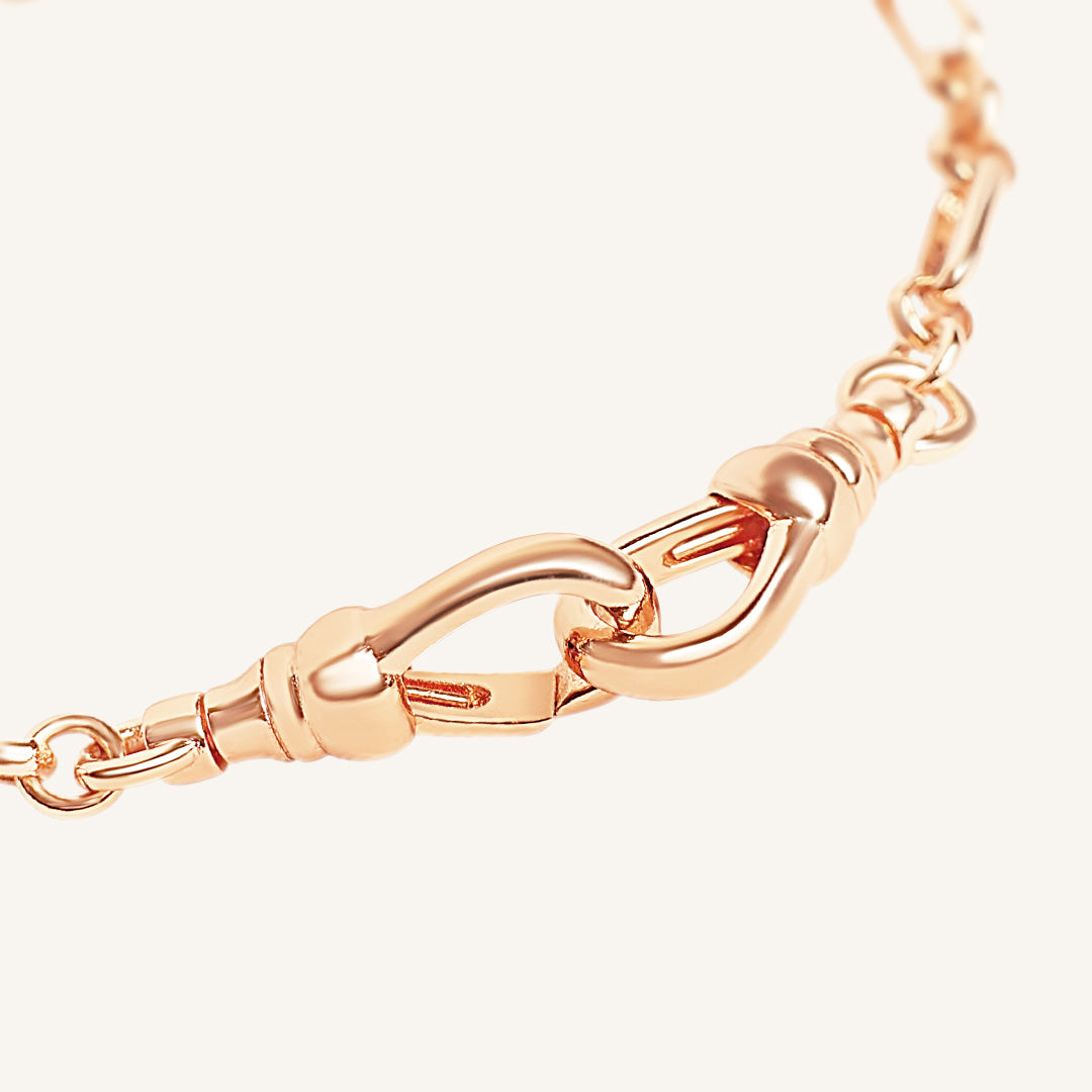 Rose gold chain bracelet on a white background