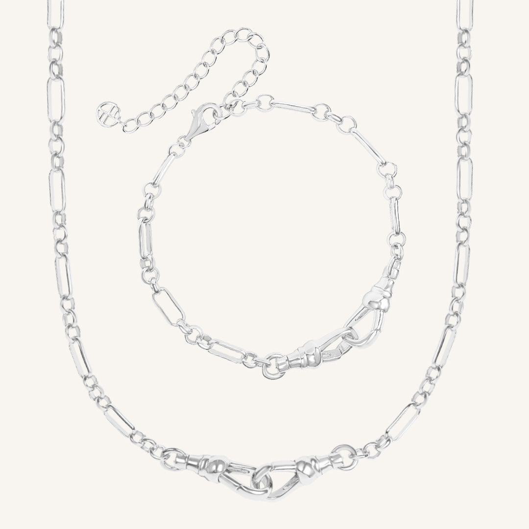 Silver chain necklace and bracelet on a white background