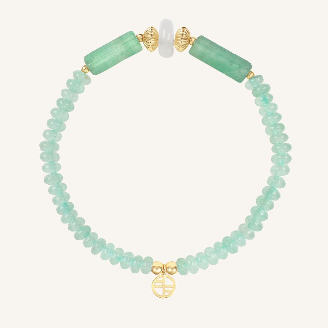 Bracelet with green beads and gold accents on a white background