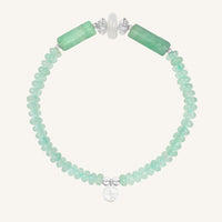 Bracelet with green beads on a white background