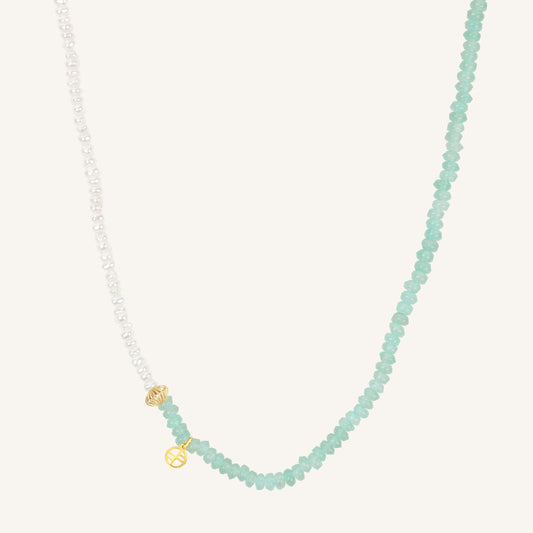 Necklace with light blue beads and gold clasp on a white background