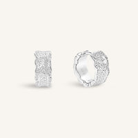 Silver hoop earrings on a light gray background