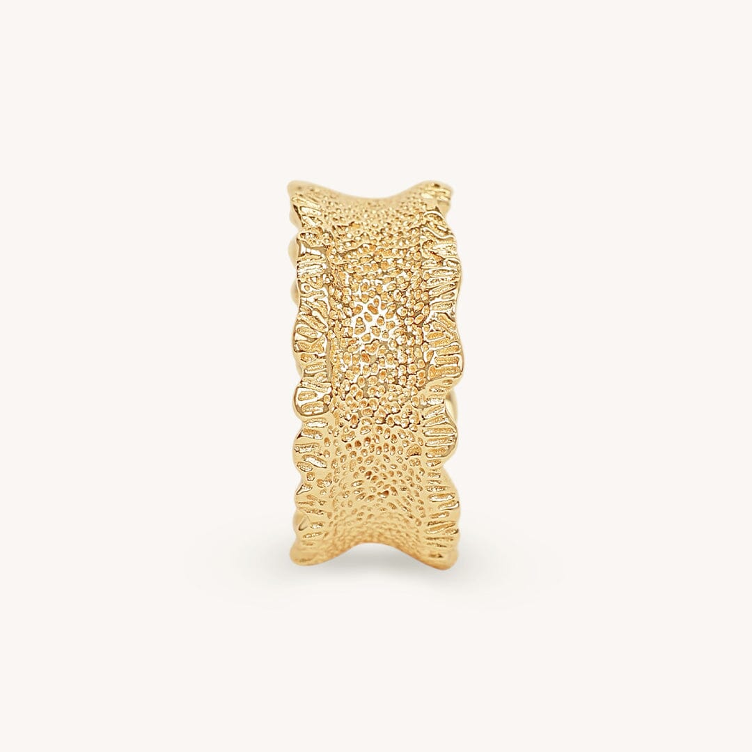 Gold textured ring on a white background