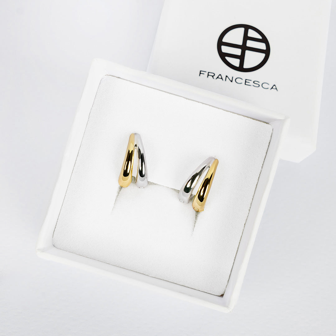 Gold and silver two tone earrings in a Francesca jewellery box.