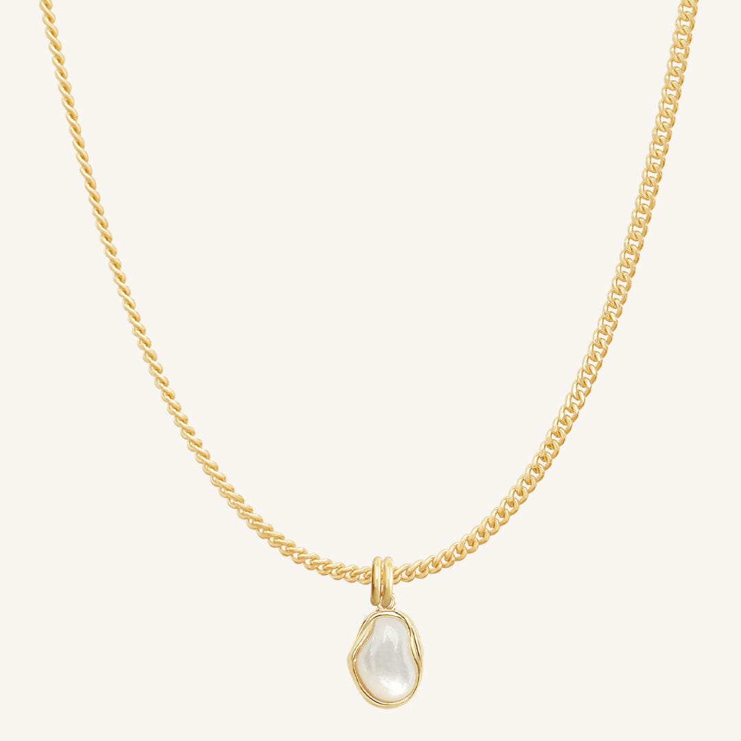 Gold necklace with a teardrop-shaped pearl pendant on a white background