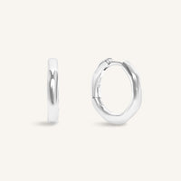 Silver hoop earrings on a light gray background