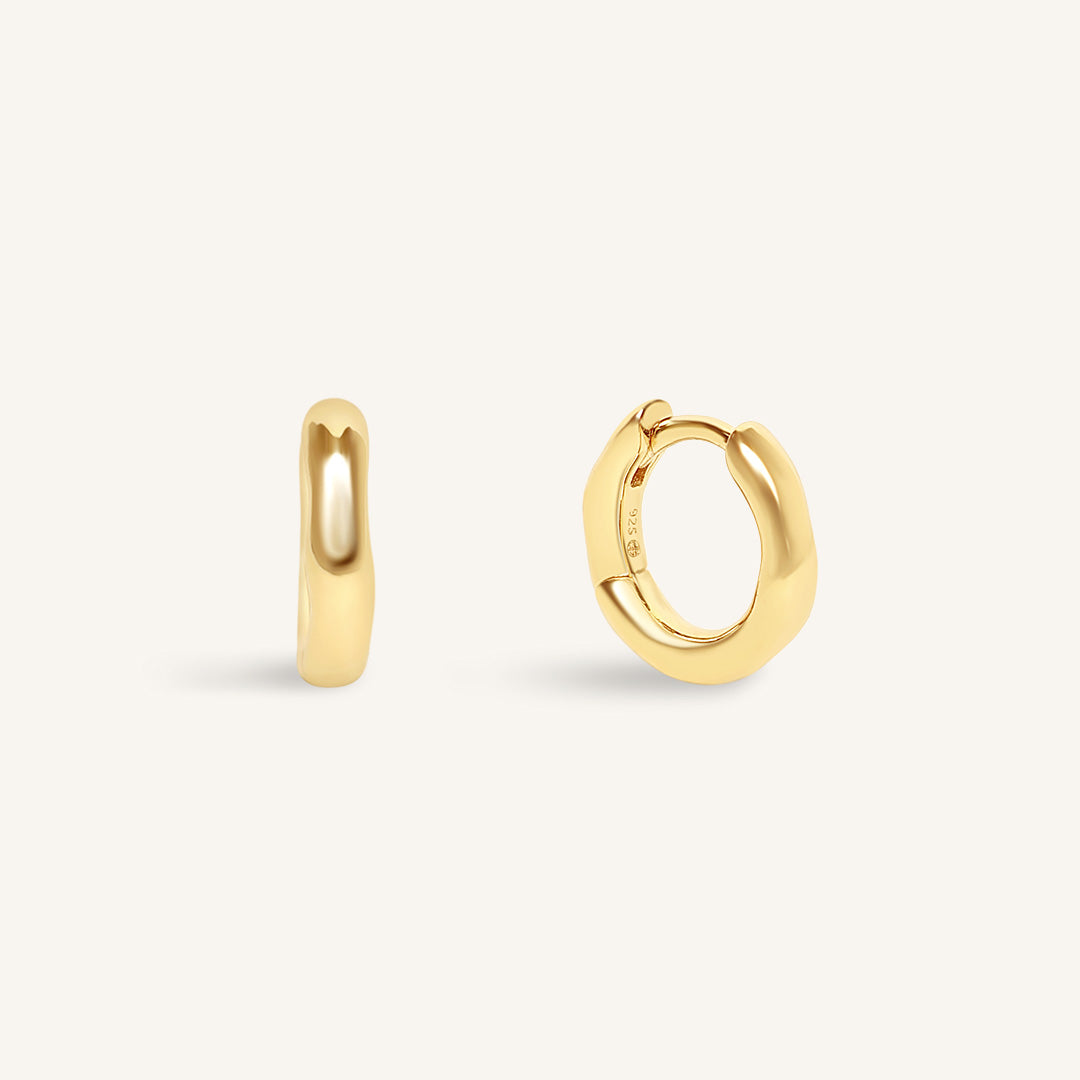 Gold hoop earrings on a white background