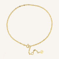 Gold anklet on a white background