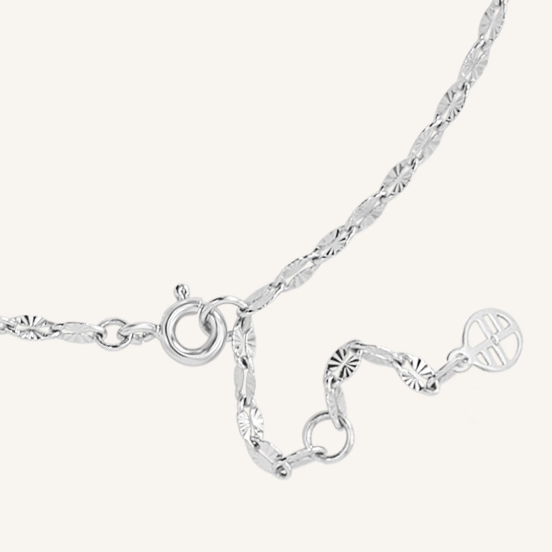 Silver bracelet with heart-shaped charms on a white background