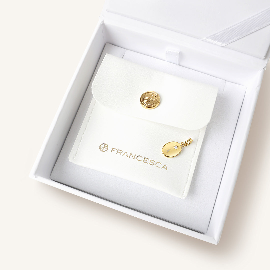 Gold jewelry with 'Francesca' branding in a white box