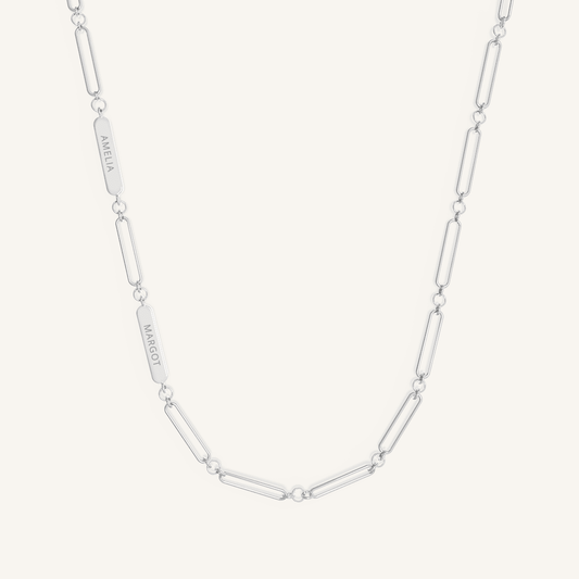 A silver chain necklace with two engraveable panels on a white background