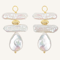 Pair of pearl hoop charms with gold accents on a white background