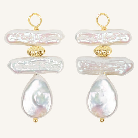 Pair of pearl hoop charms with gold accents on a white background