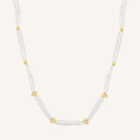 Necklace with white beads and gold accents on a white background