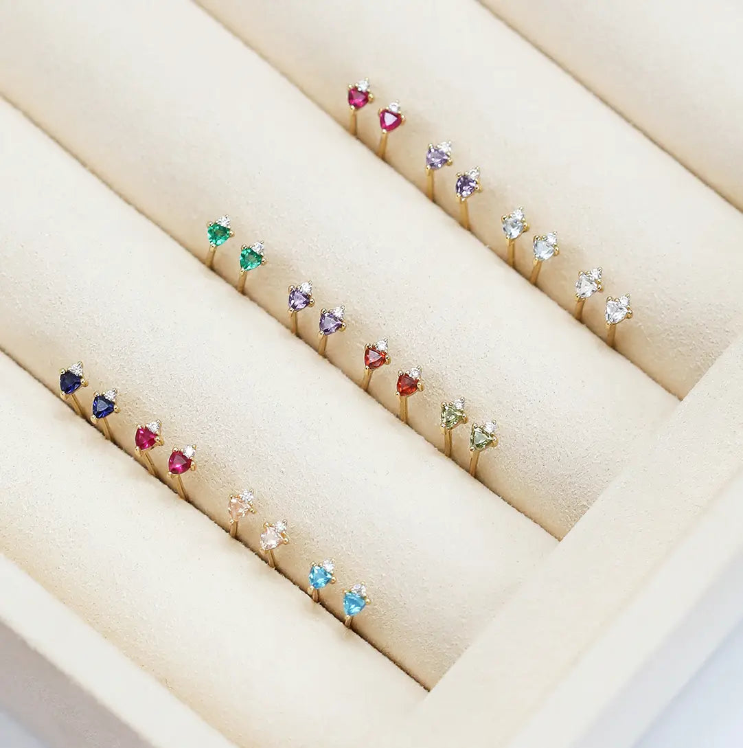 All birthstone studs displayed in jewellery box 
