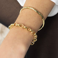 Gold chain bracelet on a white background