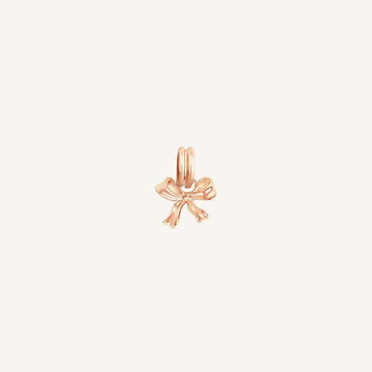A small rose bow charm with a loop on top for attachment, displayed on a white background.