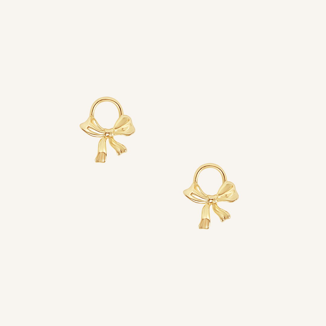 A set of two gold hoop charms with a bow design.