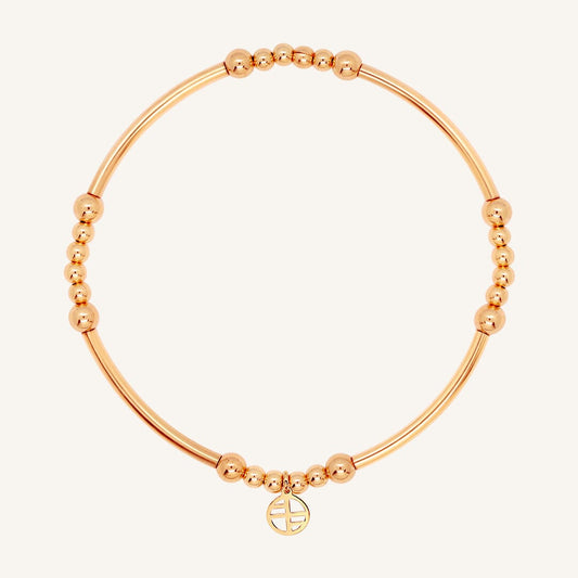 A rose-tone bracelet with spherical beads and a Francesca logo