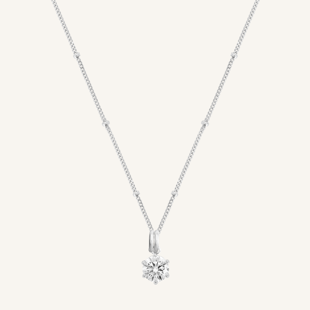 Round, silver, cubic zirconia charm on gold chain